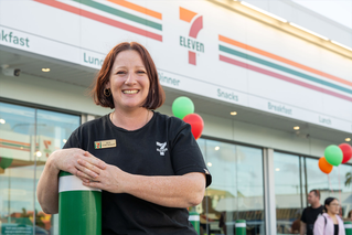 Franchisee standing in front of store